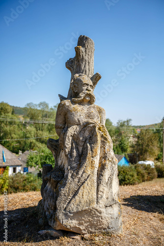 The figure of the ancient gods on the stones in the autumn park. Ukraine. Scythian culture