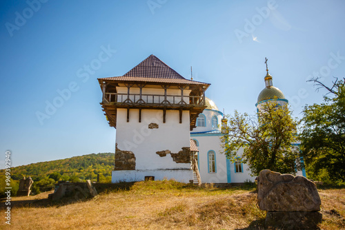 Obraz na płótnie Blue Church and Old Tower in an open air nature reserve. Busha village. Ukraine w salonie