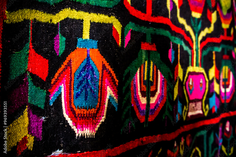 Ornament of traditional Ukrainian multicolored colorful rug. Hutsul ethnic woven smooth hand-woven wool rug with geometric ornaments background and texture. Detail of authentic local motif carpet.