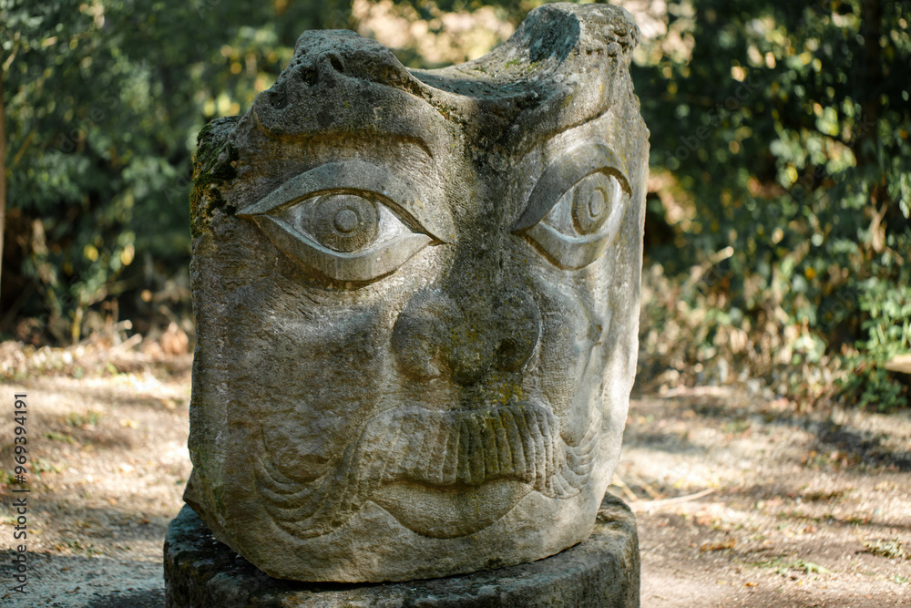 The figure of the ancient gods on the stones in the autumn park. Ukraine. Scythian culture