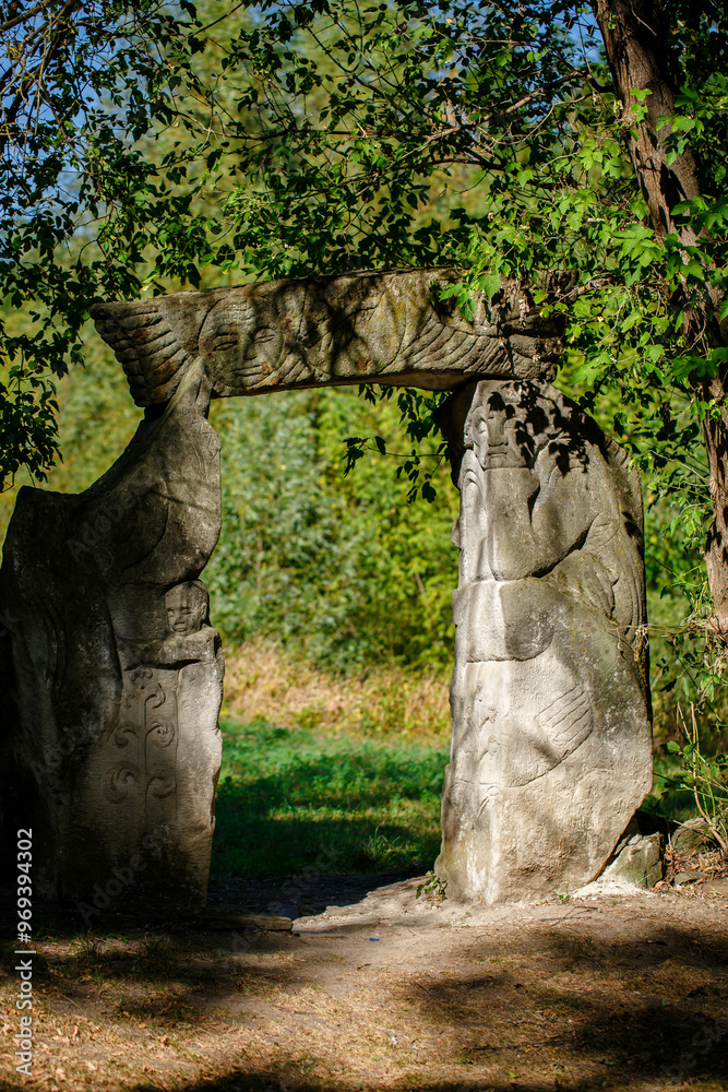 The figure of the ancient gods on the stones in the autumn park. Ukraine. Scythian culture