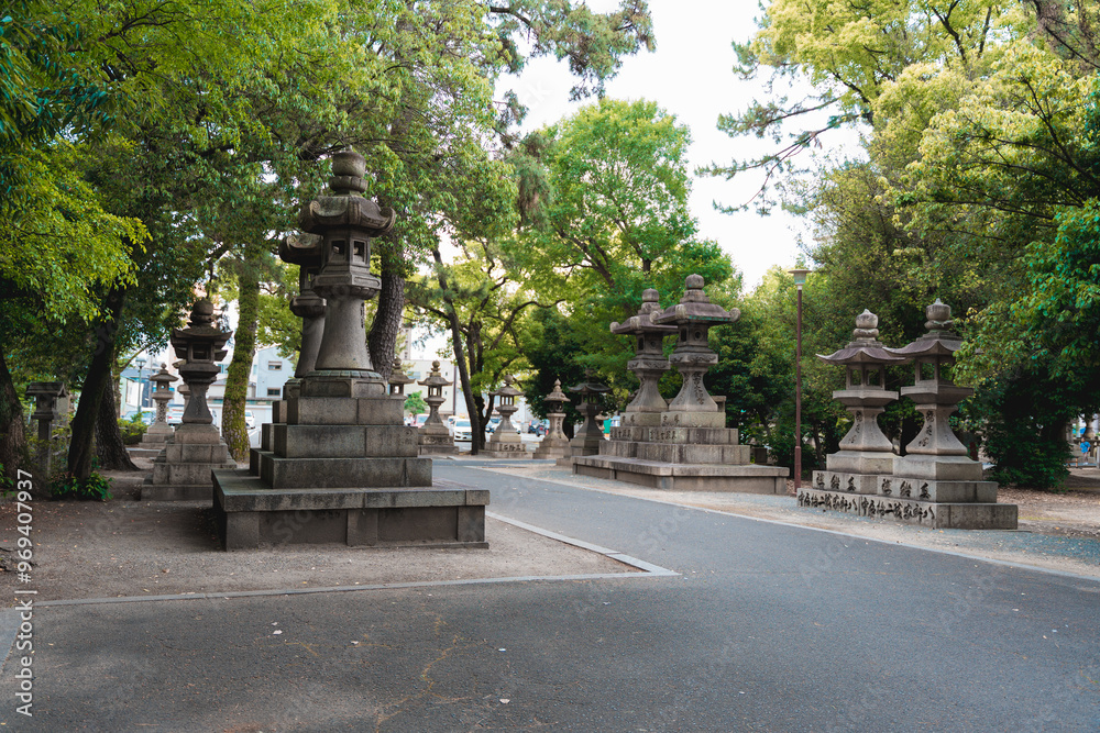 Pathway Lined with Traditional Stone Lanterns at a Japanese Shrine Pathway Lined with Traditional Stone Lanterns at a Japanese Shrine