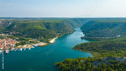 An aerial view of Skradin, a charming town near Krka National Park in Croatia. Nestled along the Krka River, the town features a picturesque marina filled with yachts and boats. photo