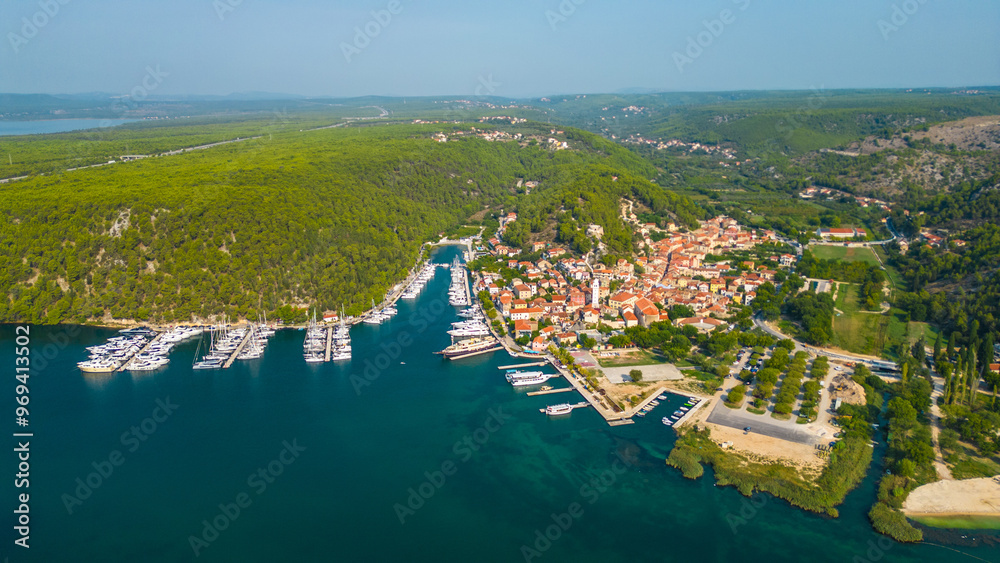 Fototapeta premium An aerial view of Skradin, a charming town near Krka National Park in Croatia. Nestled along the Krka River, the town features a picturesque marina filled with yachts and boats.