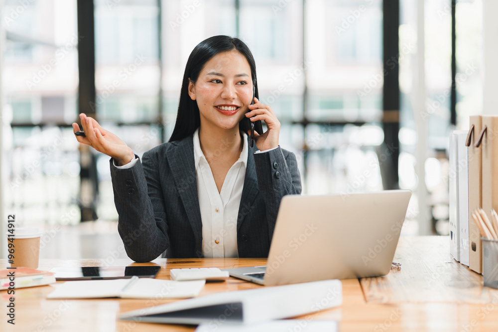 Efficient businesswoman on phone, smiling and engaged in conversation Efficient businesswoman on phone, smiling and engaged in conversation