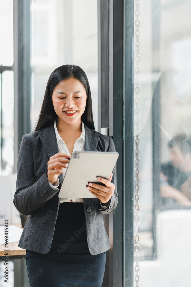 Professional woman using tablet in modern office setting, smiling confidently Professional woman using tablet in modern office setting, smiling confidently
