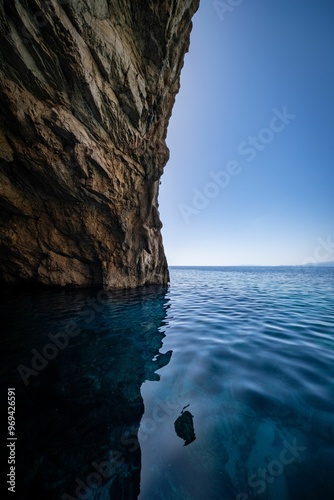 Wallpaper Mural Vertical view of a beautiful seascape with a rocky cliff on a sunny day against blue sky background Torontodigital.ca