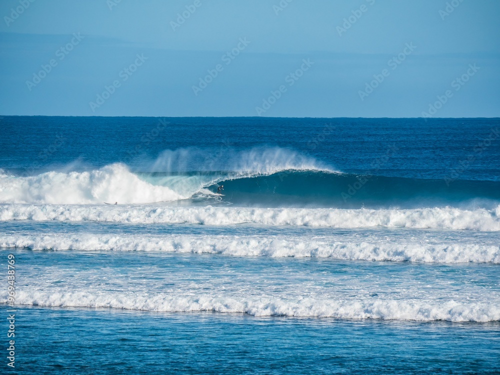 Surfer riding a wave in the ocean Surfer riding a wave in the ocean