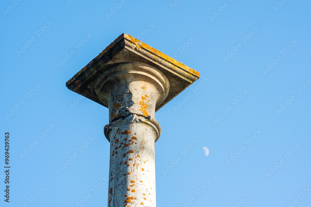 concept of antique architecture, top of ancient mossy column against sky background concept of antique architecture, top of ancient mossy column against sky background