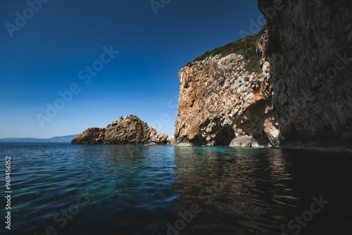 Serene water and coastal cliffs under a blue sky on a sunny day in Zakynthos island, Greece