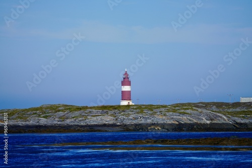 Lighthouse of Haugjegla fyr seen from the fishing village Veiholmen, Smoela, Norway photo