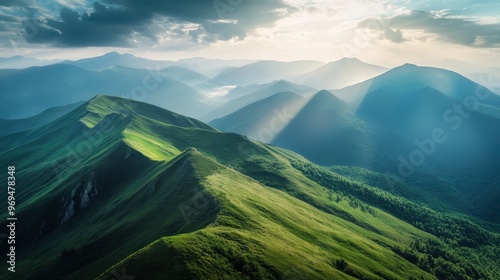 A breathtaking view from a mountain summit, with rolling hills and valleys stretching out into the distance. photo