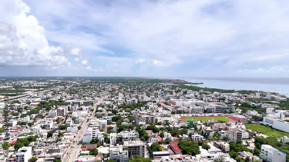 Aerial drone view of downtown playa del carmen with houses and stadium near the coastline with Caribbean Sea on a cloudy morning Aerial drone view of downtown playa del carmen with houses and stadium near the coastline with Caribbean Sea on a cloudy morning