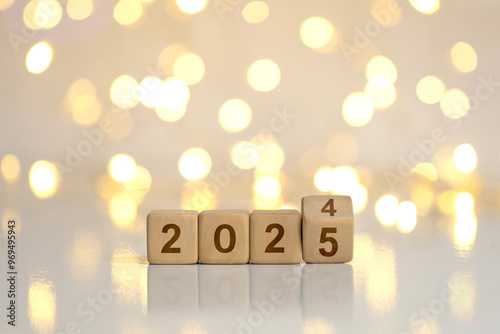 New Year Goals 2025. Flipping numbers 2024 to 2025 on a wooden block cube on a light bokeh background for preparation for the New Year change holiday. Happy New Year 2025.new Year's Eve Celebration. photo