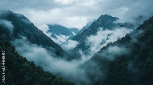 A majestic view of a mountain range with dense clouds rolling over the peaks, creating a dramatic and mystical atmosphere.