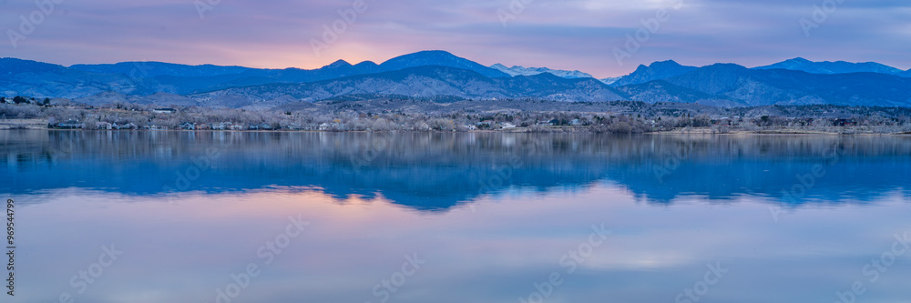 Fototapeta premium dusk over calm lake in Colorado foothills of Rocky Mountains, Boedecker Reservoir in early spring - panorama