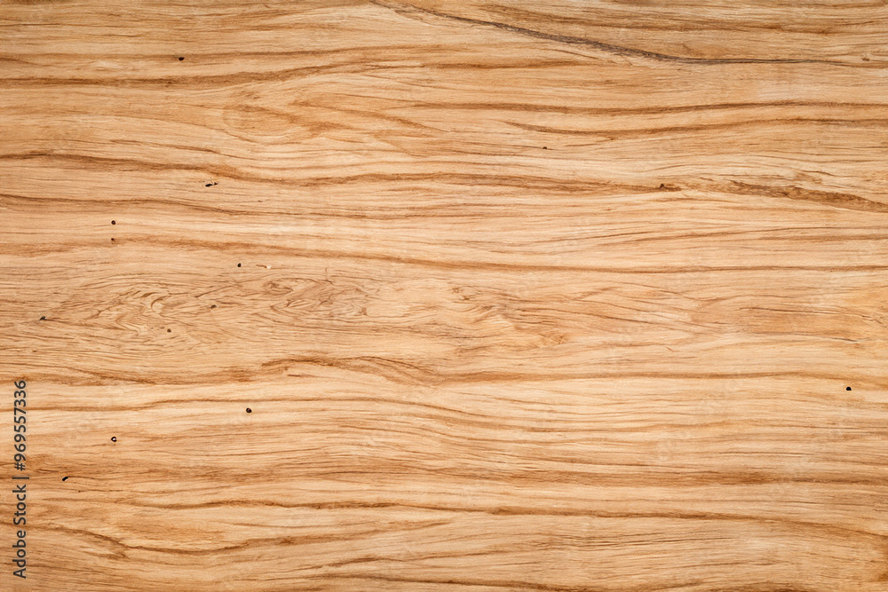 Close-up view of a light brown wooden surface with natural grain patterns. Close-up view of a light brown wooden surface with natural grain patterns.