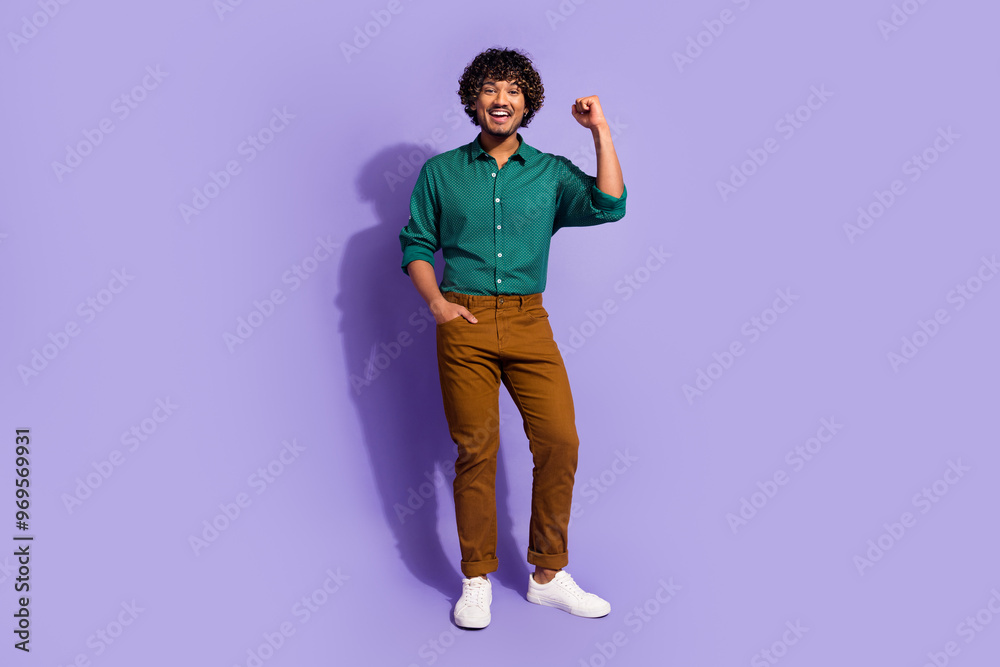 Fototapeta premium Photo portrait of funny arabian businessman with curly hair in casual outfit raised fist up champion isolated on violet color background
