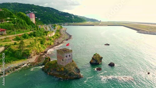 Aerial view a lighthouse on a cliff.