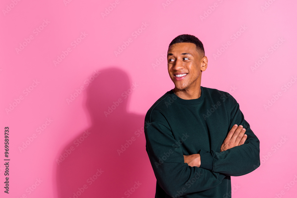 Photo of handsome good mood guy wear sweatshirt arms folded looking back emtpy space isolated pink color background Photo of handsome good mood guy wear sweatshirt arms folded looking back emtpy space isolated pink color background