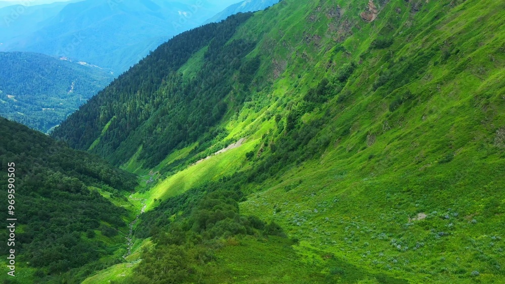 Obraz premium Lush Green Mountainous Landscape with Valleys and Slopes