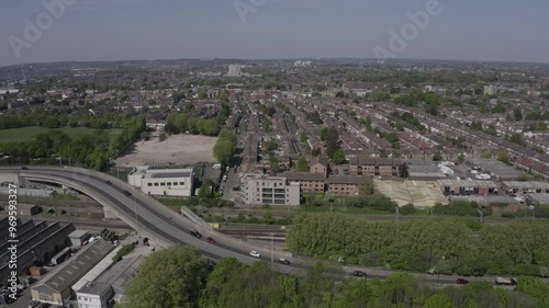 Aerial of Tottenham Hale residential streets tilting down from Tottenham Hotspur Stadium over Harris Primary and surrounding suburban houses photo