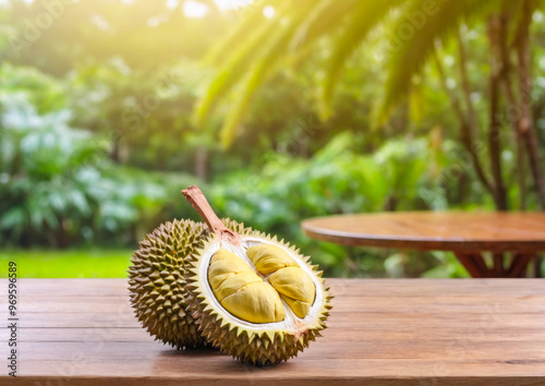 Durian Fruit on Wooden Table with Blurred Garden Background. photo