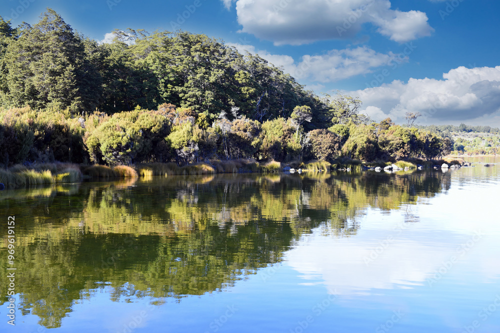 Tranquil morning sunrise mood at the Lake Te Anau with reflections in the water, Fiordland, South Island, New Zealand Tranquil morning sunrise mood at the Lake Te Anau with reflections in the water, Fiordland, South Island, New Zealand