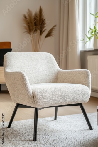 A stylish armchair with a modern design, featuring soft fabric and sleek legs, perfect for contemporary living spaces.