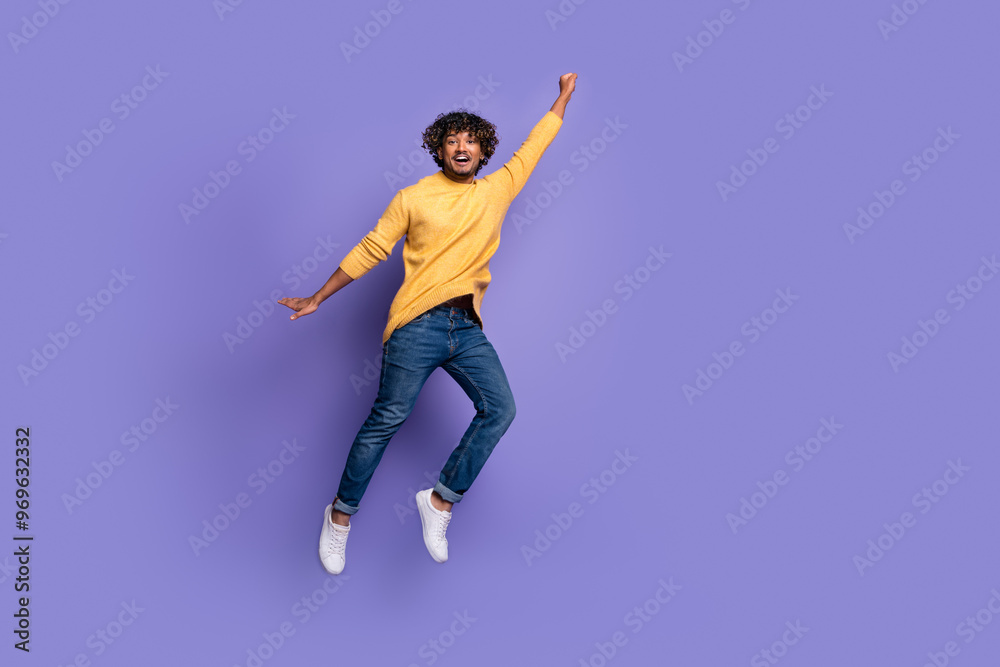 Photo of cheerful glad nice man wear stylish yellow clothes flight isolated on purple color background Photo of cheerful glad nice man wear stylish yellow clothes flight isolated on purple color background