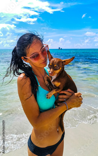 Pretty woman with dog on beach Playa del Carmen Mexico. photo