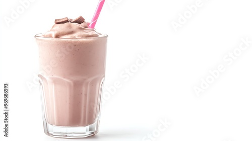 A delicious pink milkshake topped with chocolate pieces, served in a clear glass with a straw, perfect for a sweet treat.