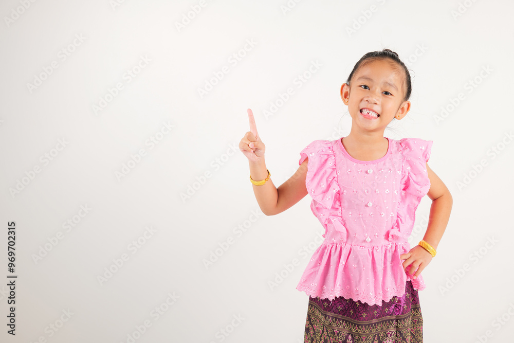 Portrait Thailand kid girl smiling traditional Thai dress costume indicate finger empty space, studio isolated white background, kindergarten child pointing index out with copy space Portrait Thailand kid girl smiling traditional Thai dress costume indicate finger empty space, studio isolated white background, kindergarten child pointing index out with copy space