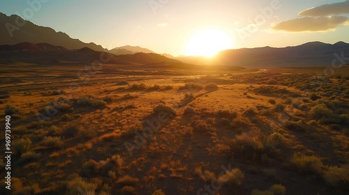 Sunrise over the Toiyabe Mountains with golden light illuminating the rugged terrain along the Nevada Loneliest Road in America photo