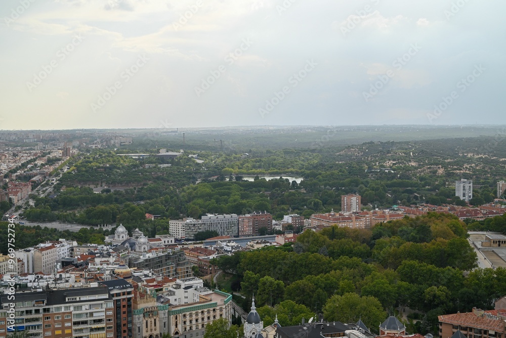 Aerial view of Madrid skyline with green trees and historical buildings. Aerial view of Madrid skyline with green trees and historical buildings.