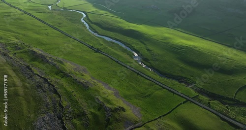 Aerial shot of a straight road in a green valley photo