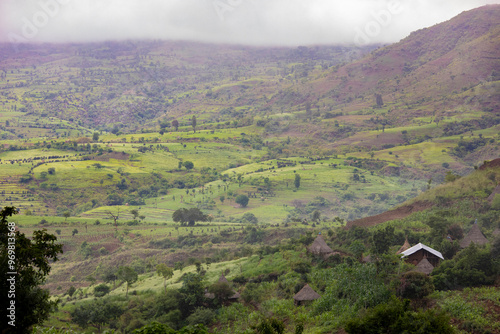 Farm fields in the lush mountains near Konso, Ethiopia with grass huts. photo