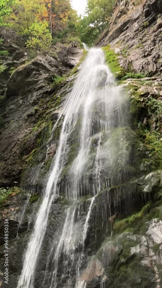 Sutovsky waterfall, Mala Fatra, Slovakia. Water flowing down from the rock. Nature in the summer. Vertical video. Sutovsky waterfall, Mala Fatra, Slovakia. Water flowing down from the rock. Nature in the summer. Vertical video.