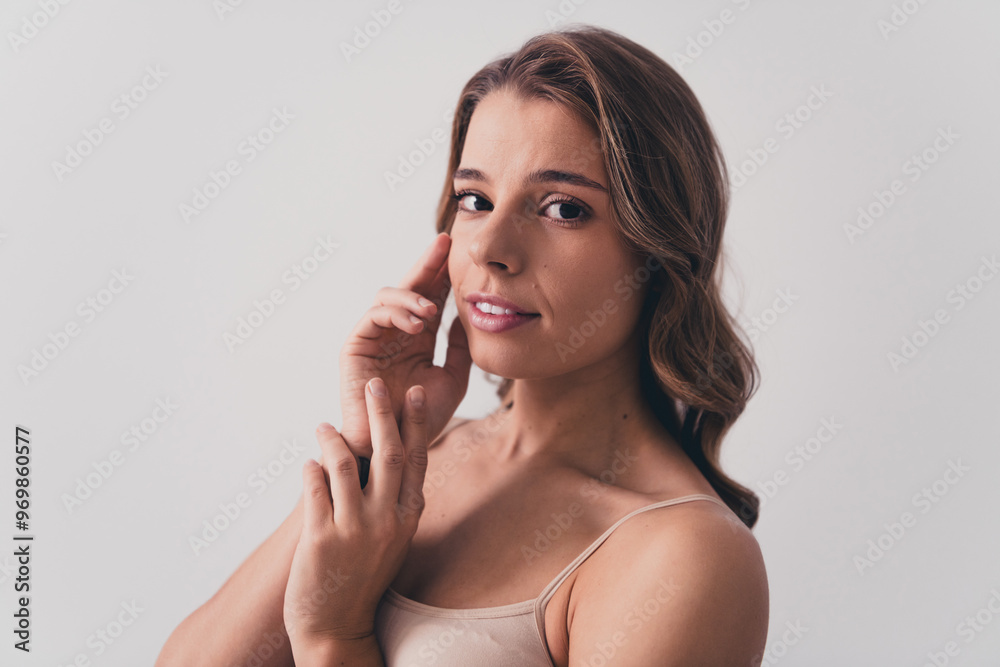 Photo of attractive young woman touch soft face skin no filter naked shoulders isolated on gray color background Photo of attractive young woman touch soft face skin no filter naked shoulders isolated on gray color background