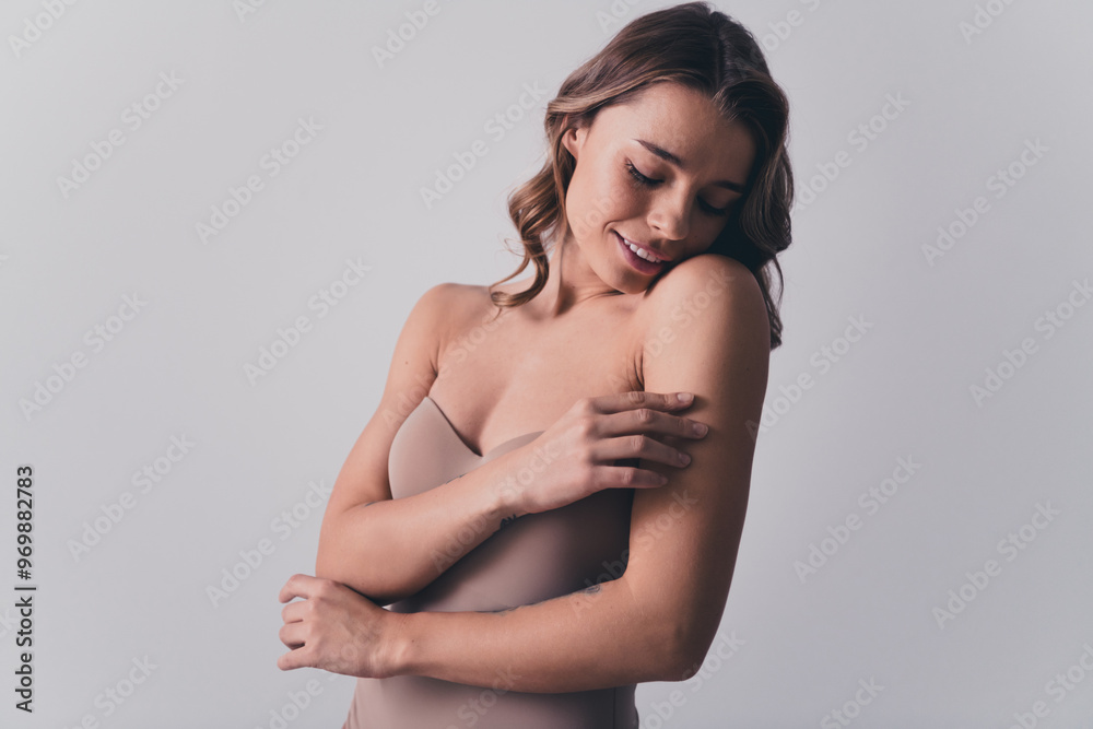 Photo of lovely young lady touch body shoulder skincare no retouch isolated on gray color background Photo of lovely young lady touch body shoulder skincare no retouch isolated on gray color background