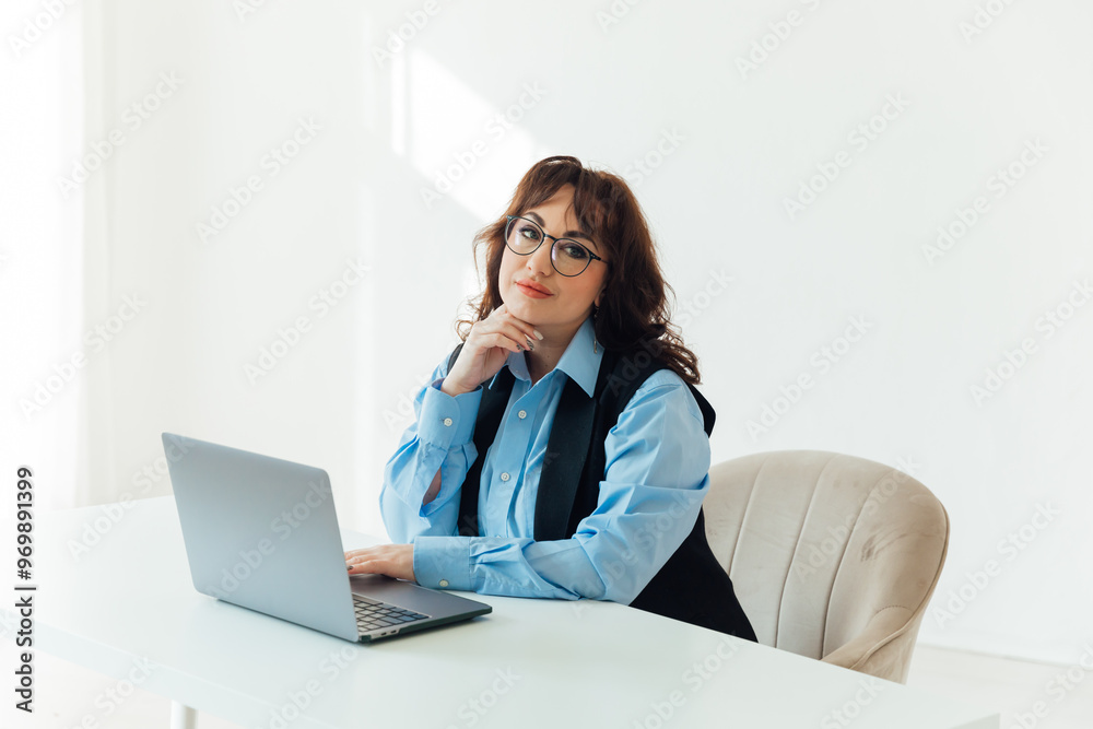 business woman in glasses working on laptop online training in office business woman in glasses working on laptop online training in office