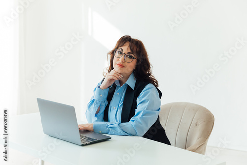 business woman in glasses working on laptop online training in office