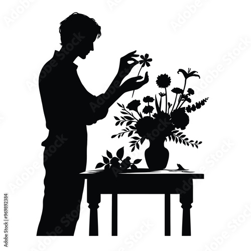 Silhouette of a person arranging flowers