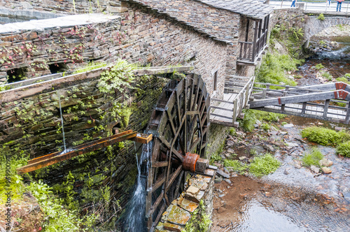 Traditional water mill in operation with visible parts photo