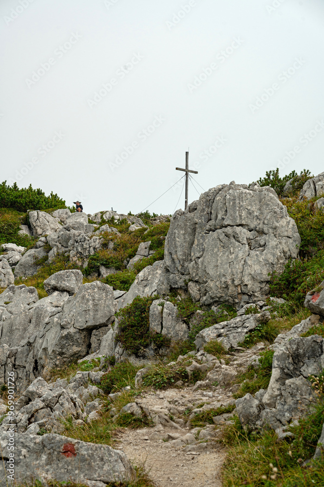 Fototapeta premium rocky path to the Belgian Cross on Top of the Steinplatte mountain near Waidring in Tyrol in Austria