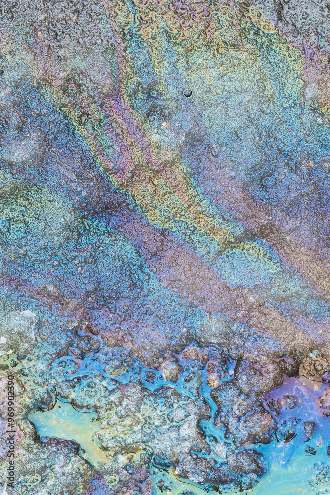 Colorful oil spill patterns on water surface Colorful oil spill patterns on water surface