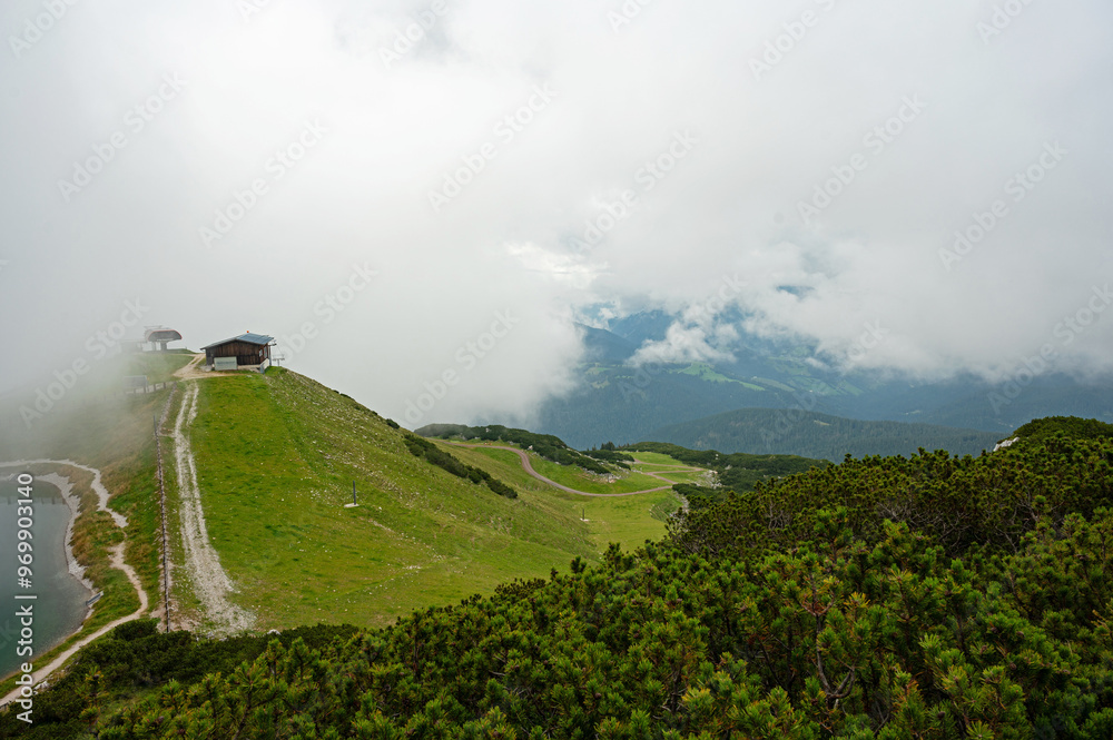 Obraz premium panorama on top of the Steinplatte mountain near Waidring in Tyrol in Austria with foggy clouds over a lake