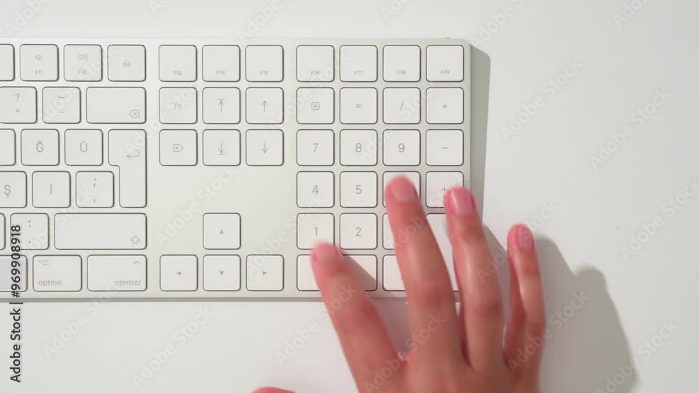 Closeup shot of hand typing numbers on keyboard Closeup shot of hand typing numbers on keyboard