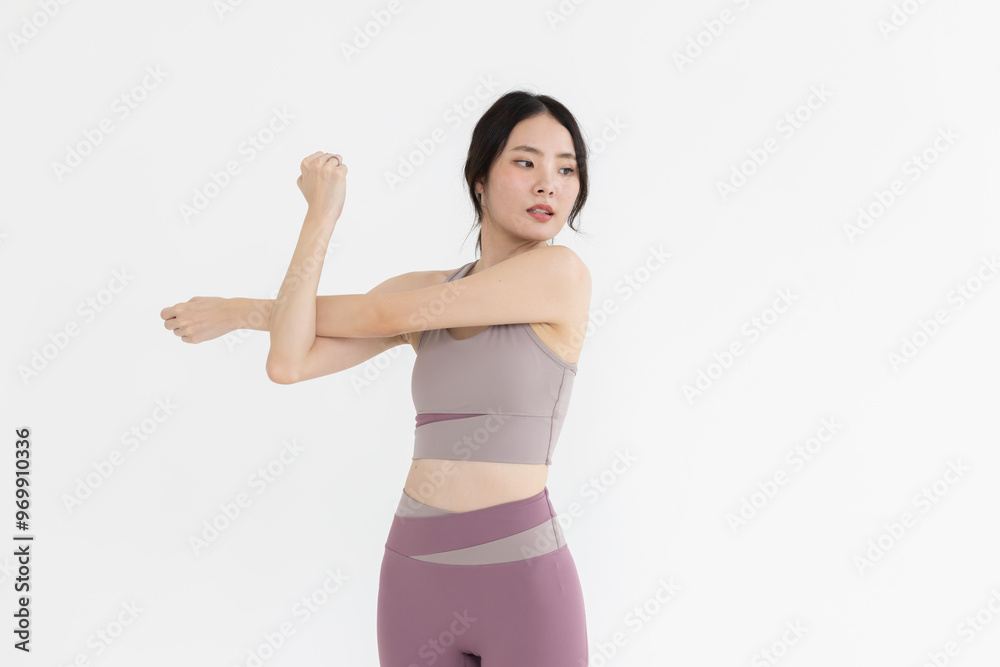 Isolated asian woman with shoulder stretching pose Isolated asian woman with shoulder stretching pose