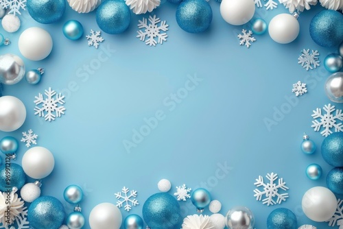Empty light blue New Year background with blue and white balls, snowflakes Christmas frame or greeting card, top view festive surface with copy space.